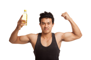 Muscular Asian man flexing biceps with electrolyte drink