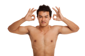 Muscular Asian man show OK sign