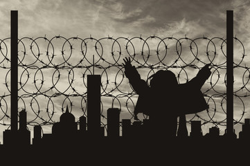 Silhouette refugee fence