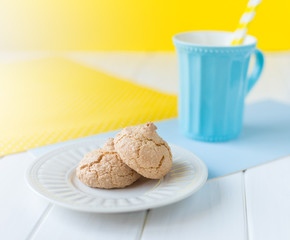 Vanilla cookies stacked on a plate on a wooden table, selective focus