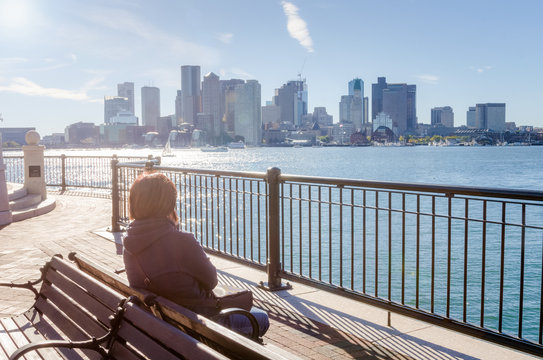 Woman Sitting on a Bench and Enjoying the View on a Warm Autumn Afternoon
