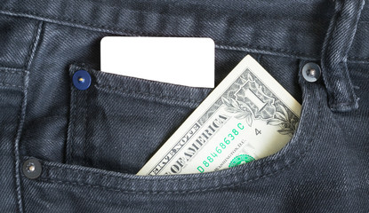 Blank business card and one dollar  in a pocket of gry worn out jeans.