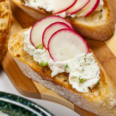 Radish and Cream Cheese toasts. Selective focus.