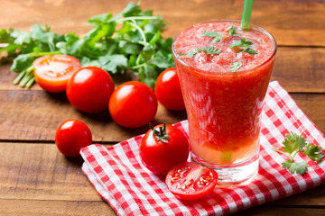 Tomato smoothie on wooden background