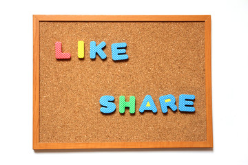 Cork board with like and share wording