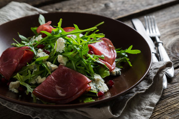 Delicious salad with arugula, cheese and dried beef