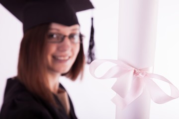 Young girl in student mantle with diploma