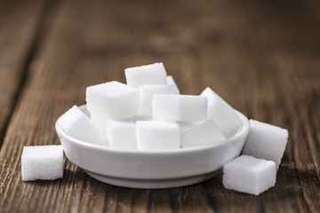 White Sugar (selective focus) on wooden background