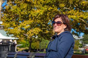 Woman Sitting on a Bench in a Park