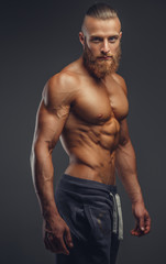 Shirtless muscular man with beard.