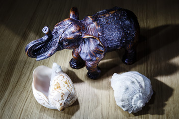 elephant figurine on a wooden table simple low key