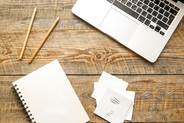 Comfortable working place with wooden table and laptop at sunlight