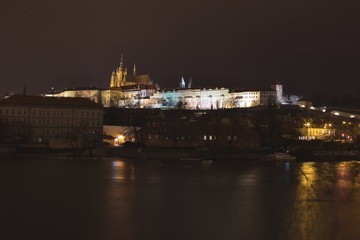 Fototapeta na wymiar Night panoramatic landscape or citiline Picture of the Prague castle in the capitol of Czech Republic Prague. On the picure are Vltava river, small town quater, gardens and Saint Vitus cathedral.