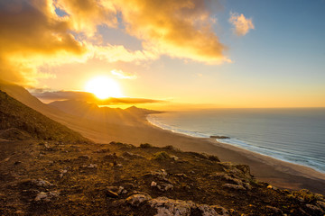 Top view on Cofete beach and mountains on Jandia peninsula on Fuerteventura island on the sunset in Spain