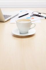 Office desk workplace with laptop and coffee
