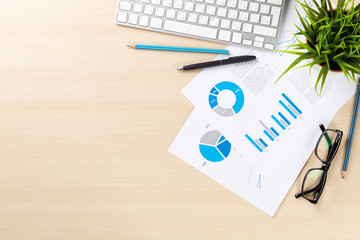 Office desk workplace with pc and charts