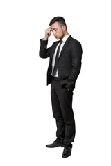 Full portrait of young man in business suit, thinking about something, isolated on a white background