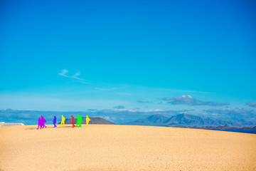 Deserted landscape view with colorful tourist silhouette and mountains on the background no Fuerteventura island in Spain