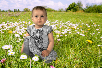 Little girl on a flowering meadow