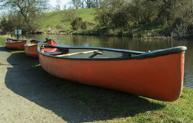 red canoes on canal bank