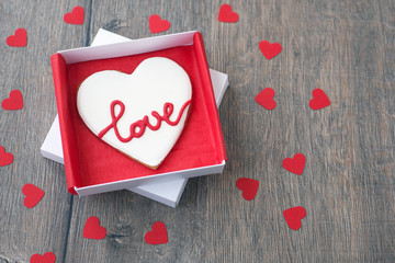 Gingerbread cookie decorated for valentine day in the paper box