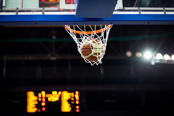 Basketball going through the hoop at a sports arena