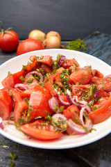 Traditional tomato salad with sweet onion and allspice .  Rustic style .
