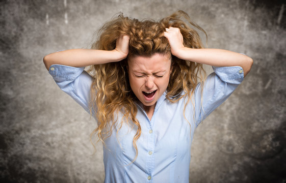 Angry and stressed woman pulling her hair