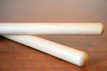 Pair of Drumsticks on Faux Wooden Surface
