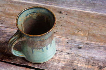 Rustic Clay Mug on a Old Barn Board Floor