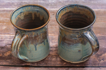 Two Rustic Clay Mugs on a Old Barn Board Floor