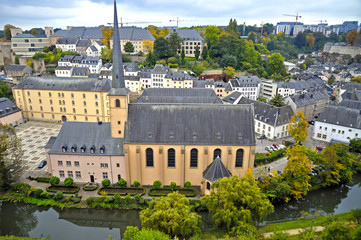 Arial view of Grund district of Luxembourg City seen with Neumuenster Abbey and Alzette river
