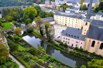 Fototapeta na wymiar Arial view of Grund district of Luxembourg City seen with Neumuenster Abbey and Alzette river