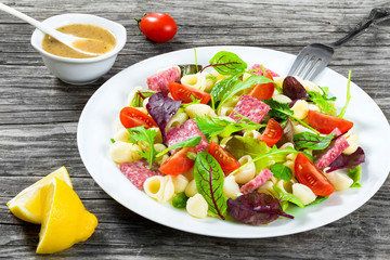 lettuce leaves, salami , nuts, honey, sesame seeds sauce, close-