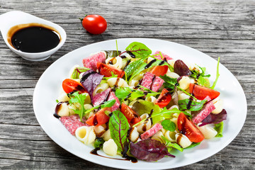 lettuce leaves, salami , nuts, honey, sesame seeds sauce, close-
