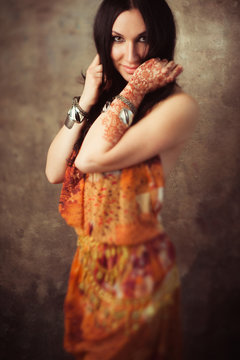 Tender indian woman in traditional clothing with mehndi on hand. Playful indian girl in  sari with mehndi. Beautiful lady in indian dress