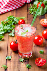 Tomato smoothie on wooden background