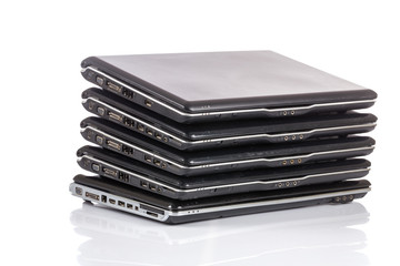 stack of old laptops awaiting repair