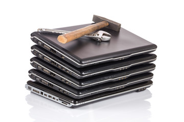 stack of old laptops awaiting repair