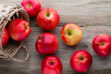 Ripe red apples on wooden background.