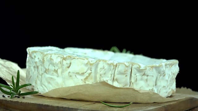 Portion of rotating creamy Camembert as detailed 4k footage (not seamless loopable)