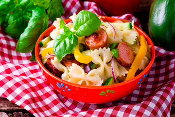 pasta salad with  sausages and vegetables. selective focus