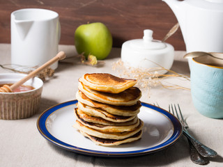 Breakfast with yogurt pancakes on beige table cloth