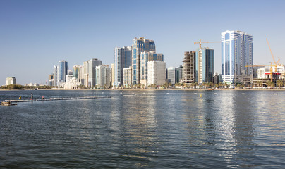 Fototapeta na wymiar reflections of skyscrapers in water in city in united emirates