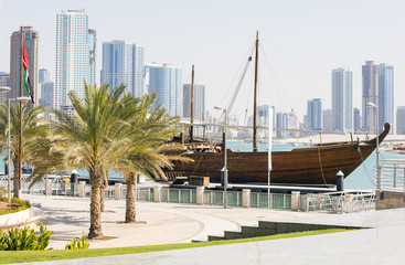 Fototapeta na wymiar view to old boat and palm trees on the bank in united emirates