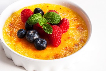 Creme brulee Dessert wih fruits and mint leaves