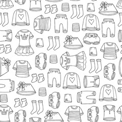 Vector seamless pattern with hand drawn isolated clothes for girls on white color