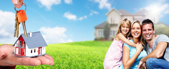 Happy family near new house.