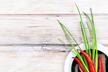 Red hot chilli pepper and scallions on plate