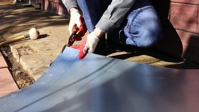 Video worker on a construction site cut stainless steel sheet shears of metal cutting 